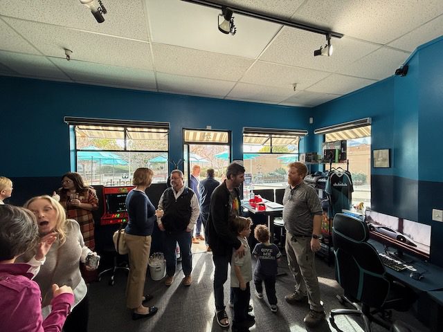 A group gathered inside DubDub AI Arcade near gaming stations