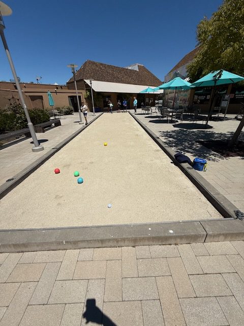 Bocce balls set up on the Bon Air Center court near DubDub AI Arcade