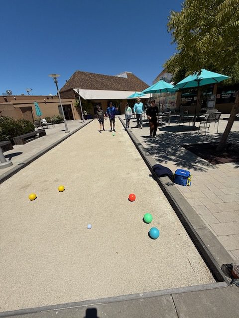 Bocce balls on the Bon Air Center patio near DubDub AI Arcade