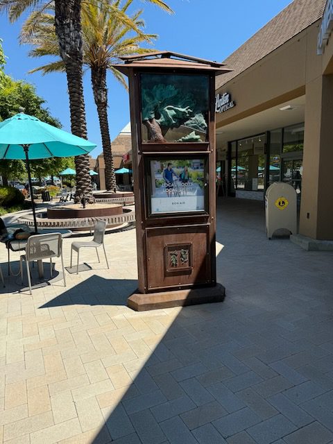 Outdoor patio kiosk and palm tree near DubDub AI Arcade