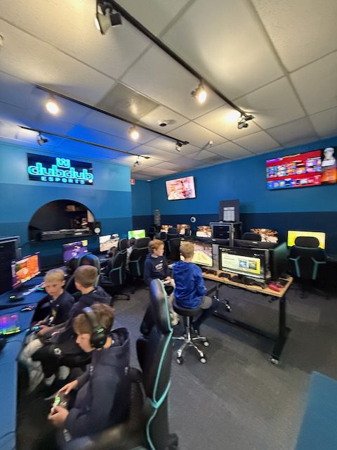 A busy DubDub AI Arcade room with kids playing at multiple stations