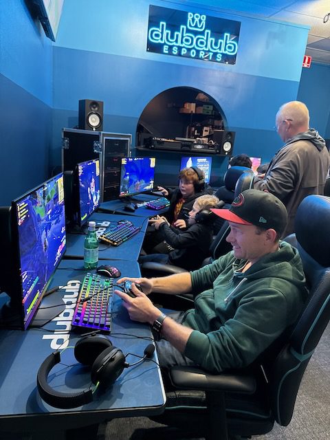 Focused player using a DubDub AI Arcade gaming station
