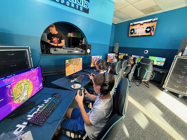 Kids playing Mario Kart together at DubDub AI Arcade stations