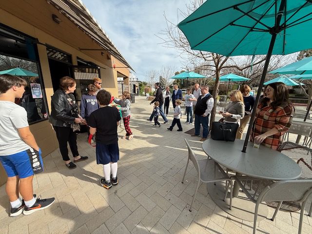 Families gathered outside DubDub AI Arcade on the Bon Air Center patio