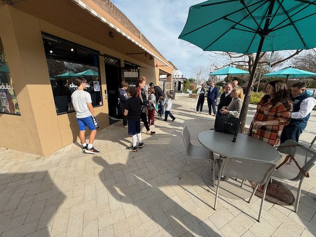 Bon Air Center patio walkway outside DubDub AI Arcade with guests nearby
